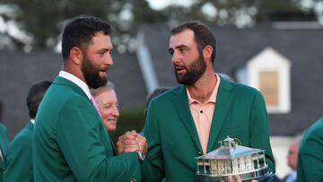 Scottie Scheffler of the U.S. and Spain's Jon Rahm shake hands after the green jacket and trophy presentation for Scheffler winning The Masters.